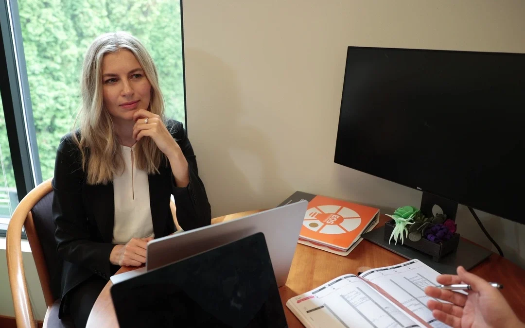 Katya Stelmakh meeting with a client, discussing immigration strategy for startup founders at her office.